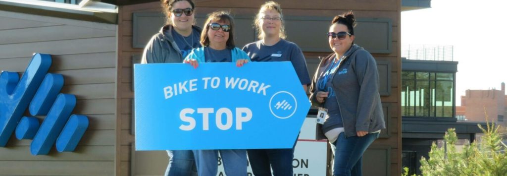 Branch staff in Cheyenne with a Bike to Work Stop sign