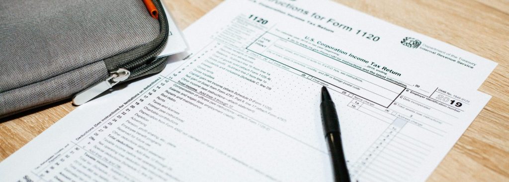 Protecting Your Finances: Tax Scams You Need to Know to Secure Your Future header image. Tax documents on a desk.