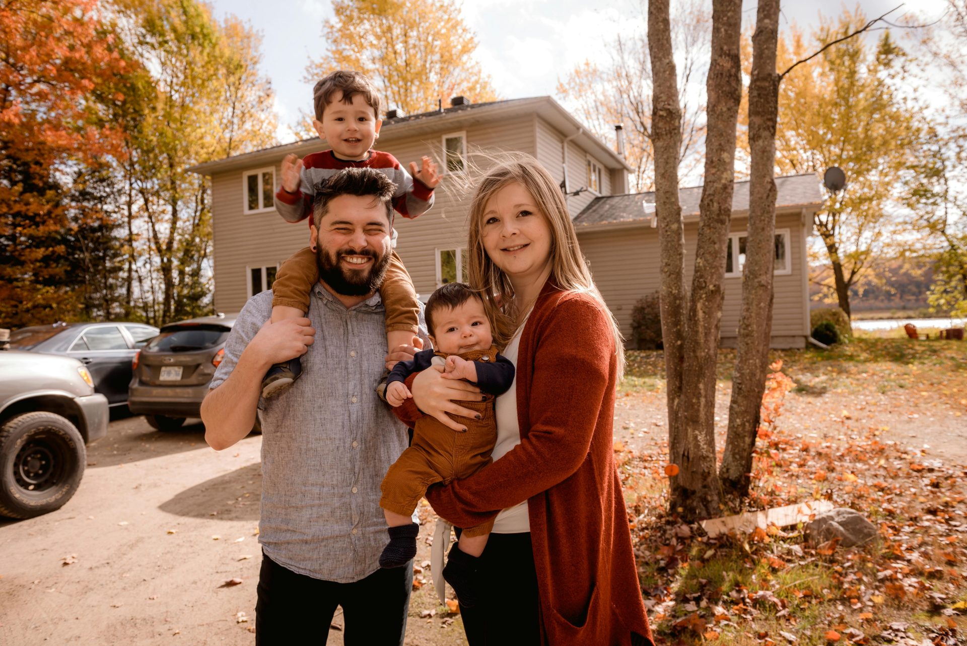 Family standing in front of home