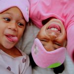 two kids in pink pajamas for the Bedtime Bash at Boost center