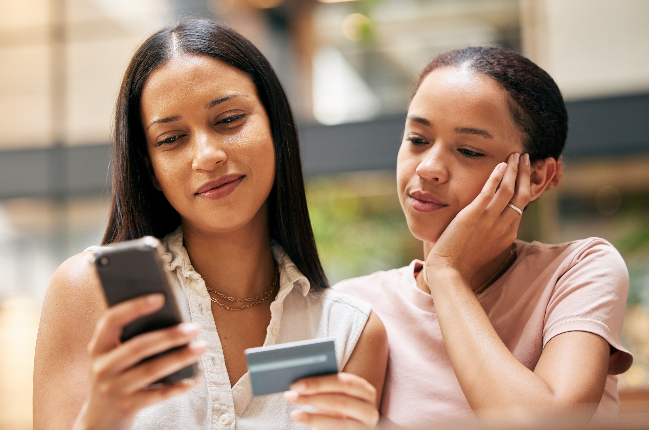 Ecommerce, credit card and smartphone with online shopping and payment, woman and young girl buying with banking and internet.