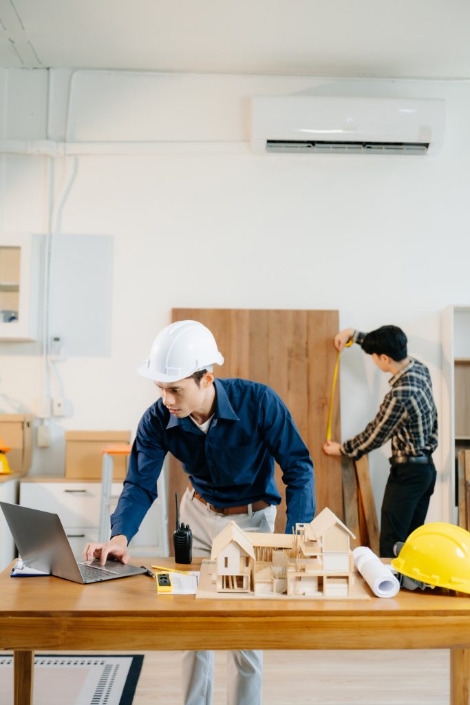 Architects and engineers collaborate on a building model, designing, planning, and measuring with teamwork, precision, and creativity in an architectural office.